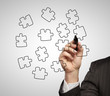 businessman drawing puzzles