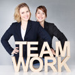 Two business women presenting teamwork