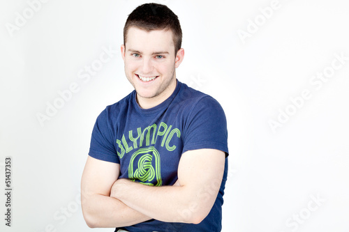 Photo: Handsome man smiling at camera with arms crossed Handsome man smiling at camera with arms crossed