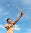 Photo: A young man shoots a bow A young man shoots a bow