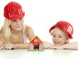 Foto: Two girls with helmet want to build a house Two girls with helmet want to build a house