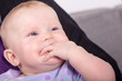 Baby schnullert at own hand