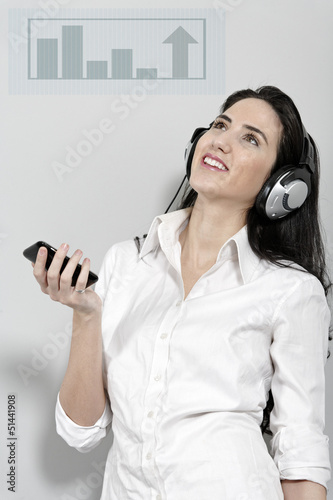 Photo: Woman holing out phone displaying volume Woman holing out phone displaying volume