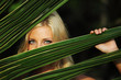 Foto: woman behind the palm leaves woman behind the palm leaves
