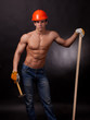 Muscular young worker  with a hammer  on a black background.