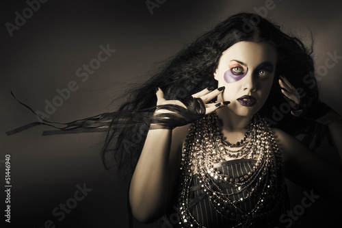 Photo: Dark beauty woman. Rich jewellery and Black Nails Dark beauty woman. Rich jewellery and Black Nails