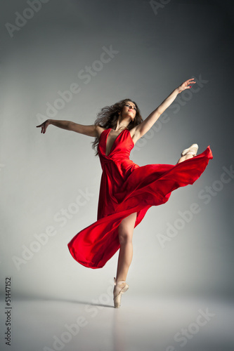 Photo: Ballet dancer wearing red dress over grey Ballet dancer wearing red dress over grey