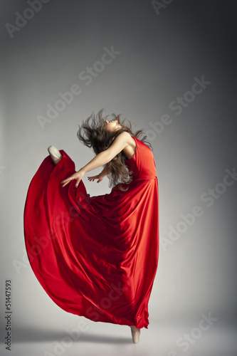 Photo: Ballet dancer wearing red dress over grey Ballet dancer wearing red dress over grey