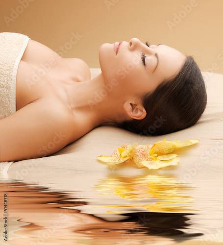 Photo: woman in spa salon lying on the massage desk woman in spa salon lying on the massage desk