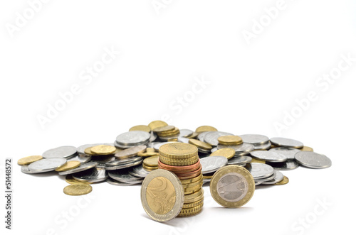 Photo: stack of coins near a heap of coins stack of coins near a heap of coins