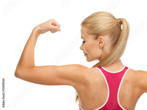 Photo: sporty woman showing her biceps sporty woman showing her biceps