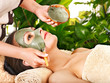 Clay facial mask in beauty spa.