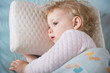 Sick and tired girl liying in bed on pillow