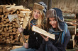Foto: two girls preparing firewood two girls preparing firewood