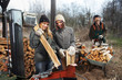 Foto: two girls at the hydraulic splitting machine two girls at the hydraulic splitting machine