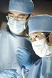 Close up of Asian surgeon working with assistant in surgery
