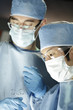 Asian surgeon working with assistant in surgery