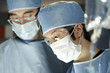 Asian surgeon working with assistant in surgery