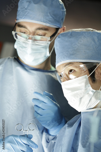 Photo: Close up of Asian surgeon working with assistant in surgery Close up of Asian surgeon working with assistant in surgery