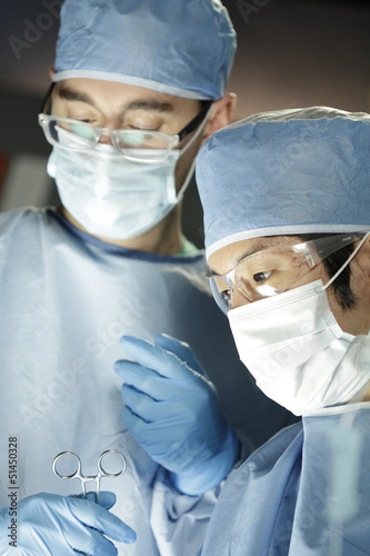 Photo: Asian surgeon working with assistant in surgery Asian surgeon working with assistant in surgery