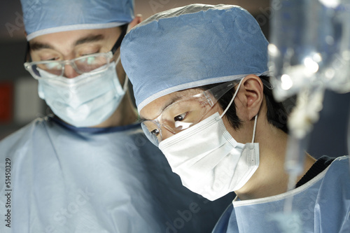 Photo: Asian surgeon working with assistant in surgery Asian surgeon working with assistant in surgery