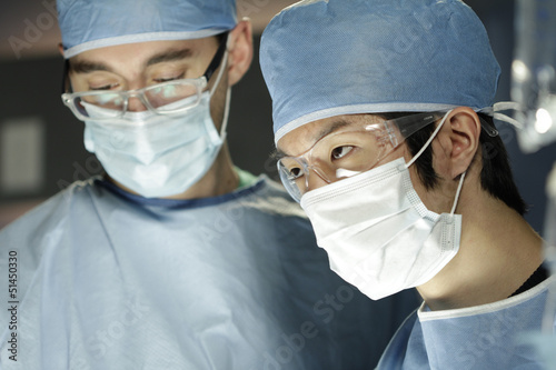 Photo: Asian surgeon working with assistant in surgery Asian surgeon working with assistant in surgery