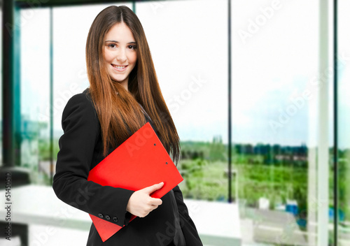 Photo: Young businesswoman holding documents Young businesswoman holding documents
