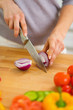 Photo: Closeup on woman cutting onion Closeup on woman cutting onion