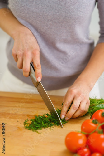 Photo: Closeup on woman cutting fresh dill Closeup on woman cutting fresh dill