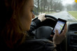 Young woman texting and driving