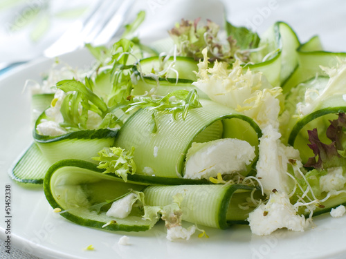 Photo: Fresh salad of cucumber, lettuce and goat cheese, selective focu Fresh salad of cucumber, lettuce and goat cheese, selective focu