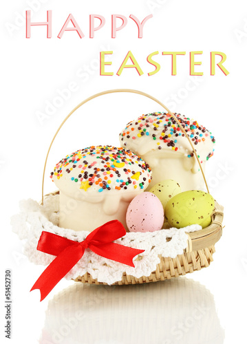 Photo: Easter cakes with eggs in wicker basket isolated on white Easter cakes with eggs in wicker basket isolated on white