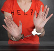 Prisoner in handcuffs behind glass in soundproof room
