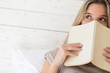 Photo: Pensive woman reading a book Pensive woman reading a book