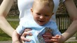 HD1080 7 Month old Baby with mother sitting on a swing.