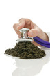 Male hand holding stethoscope on soil