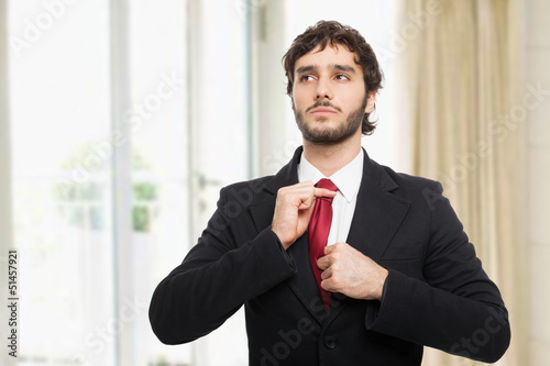Photo: Businessman adjusting his tie Businessman adjusting his tie