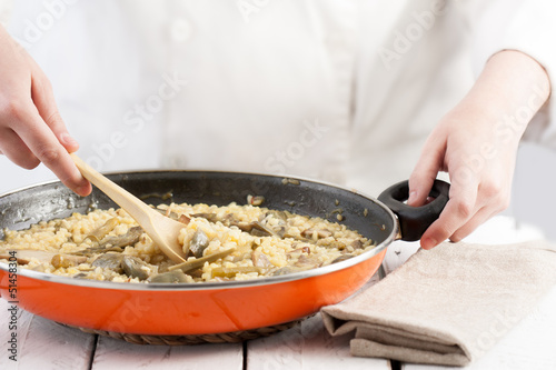 Photo: Cook mixing a ready to serve vegetables rice pan Cook mixing a ready to serve vegetables rice pan