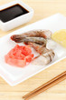 Prawn skewers on plate with ginger and lemon