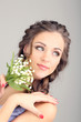 Young woman with beautiful hairstyle and flowers,