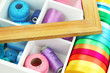 Material for sewing in white wooden box closeup