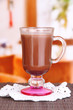 Layered coffee in glass on table on bright background