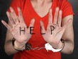 Prisoner in handcuffs behind glass in soundproof room