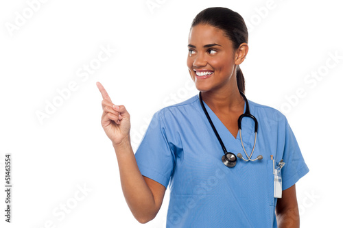 Photo: Female physician pointing and looking away Female physician pointing and looking away