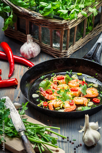 Photo: Shrimps served on a pan with fresh herbs Shrimps served on a pan with fresh herbs