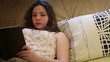 Girl reads bestseller book on comfy sofa
