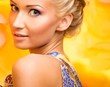 Beautiful young cheerful blond woman in colourful dress 