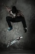 Photo: Young man in hat and shirt performing stunt on skateboard Young man in hat and shirt performing stunt on skateboard