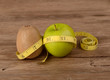Diet concept, kiwi fruit with green apple and measuring tape on