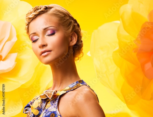 Photo: Beautiful young blond woman in colourful dress Beautiful young blond woman in colourful dress